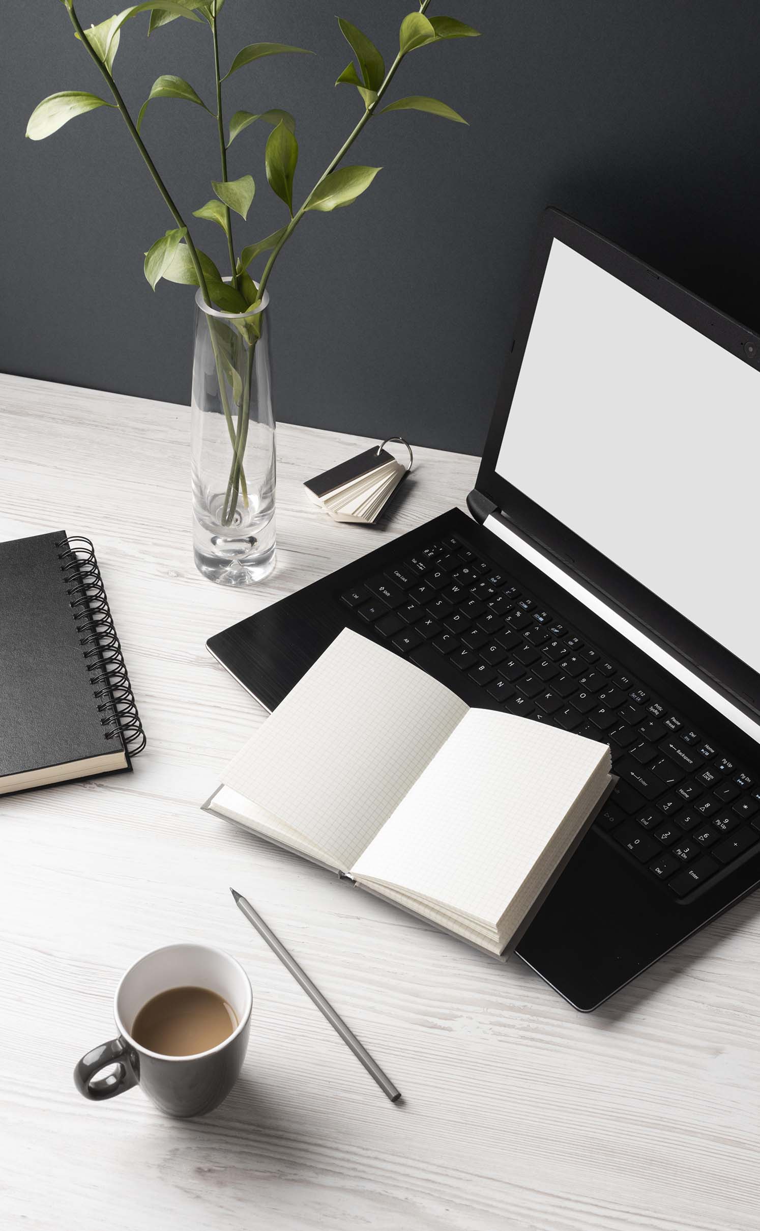 Workspace with laptop and notebook